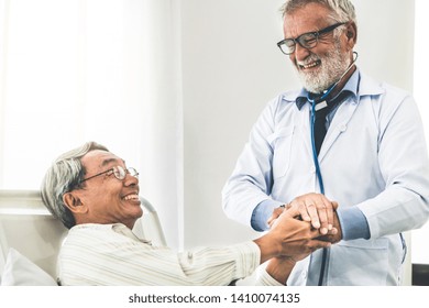 Mature Doctor Talking And Examining Health Of Senior Patient In Hospital Ward. Medical Healthcare And Doctor Staff Service Concept.