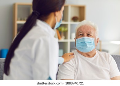 Mature Elderly Man Patient In Medical Mask Getting Support Of Young Professional Woman Doctor After Visit In Modern Medical Clinic. Visiting Doctor During Pandemic Concept