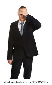 Mature Embarassed Businessman Covering His Face.