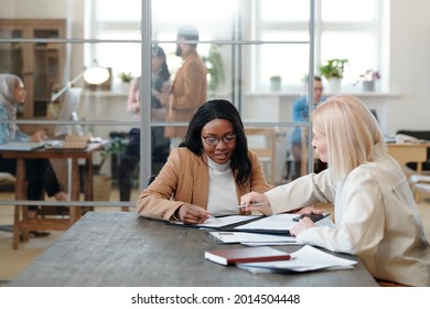 Mature employer explaining terms of contract to young African female applicant - Shutterstock ID 2014504448