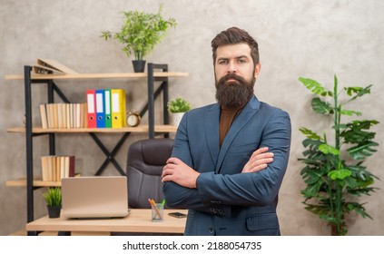 mature entrepreneur in jacket standing crossed hands at office with copy space, charisma