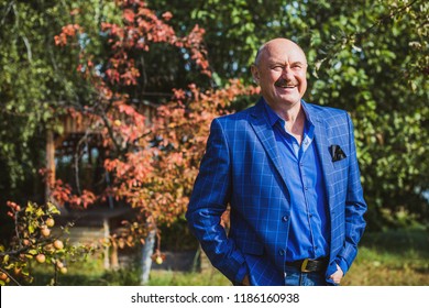 Mature European or American man with a good mood, outdoor portrait. The concept of life after 50-60 years. Positive emotions in senior life. Inspirations in everyday life