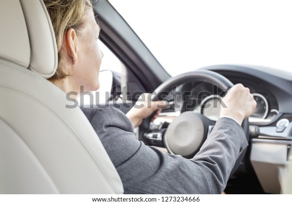 Mature\
executive driving car during business\
trip