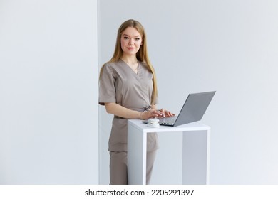 Mature Female Dentist Looking At Teeth X-ray On Computer In Clinic
