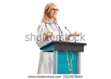 Mature female doctor giving a speech on a pedestal isolated on white background
