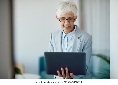 Mature Female Executive Using Computer While Working In The Office.