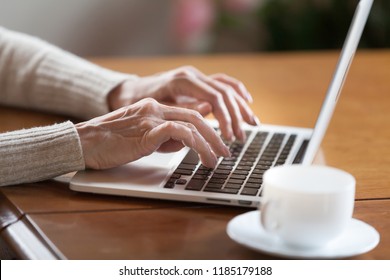 Mature Female Hands Typing Text On Keyboard, Senior Elderly Business Woman Working On Laptop, Old Or Middle Aged Lady Using Computer Concept Writing Emails, Communicating Online, Close Up View