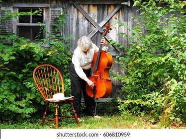 Mature Female With Her Cello Outside.