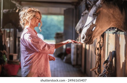 Mature female horse rider bonding with her horse - Powered by Shutterstock