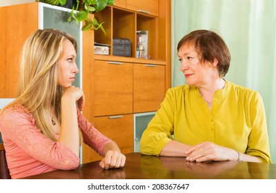 Mature Female With Sad Adult Daughter Sharing Bad News At Home