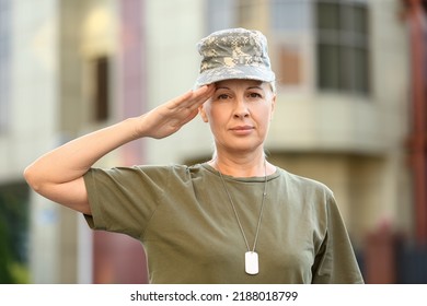 Mature Female Soldier Saluting Outdoors