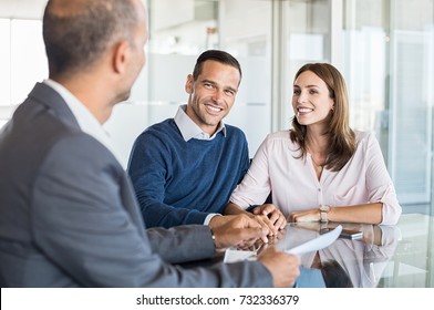 Mature financial advisor showing report to young couple for their investment. Salesman and positive couple talking about purchase. Happy couple consulting financial agent for loan.