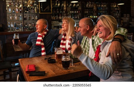 	
Mature Football And Soccer Fans Drinking Beer At The Pub And Celebrating Scores.	
