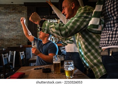 	
Mature Football And Soccer Fans Drinking Beer At The Pub And Celebrating Scores.	
