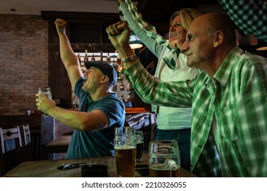 	
Mature Football And Soccer Fans Drinking Beer At The Pub And Celebrating Scores.	
