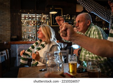 	
Mature Football And Soccer Fans Drinking Beer At The Pub And Celebrating Scores.	
