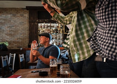 	
Mature Football And Soccer Fans Drinking Beer At The Pub And Celebrating Scores.	
