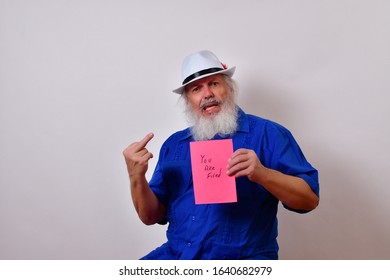 Mature Gentleman Is Holding Up A Pink Slip With The Words 