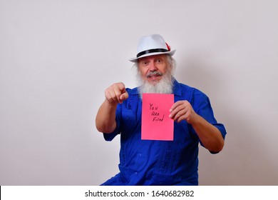 Mature Gentleman Is Holding A Pink Slip Stating 