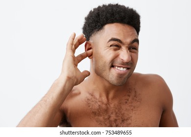 Mature Good-looking Black-skinned African Male With Curly Hair And Naked Torso Trying To Get Water From Ears After Bath In Early Morning. Man Getting Ready For Work