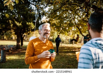 Mature Grey hair Man hangs out with his friend on the sunny day outdoors
