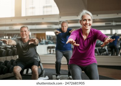 Mature group, woman and squat for exercise in gym, balance or coach for muscle development in class. Senior people, men and fitness for legs, smile or workout together in retirement at wellness club - Powered by Shutterstock