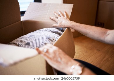 Mature hands, unpacking and open box for moving, new home and tenant in apartment, rent and person. House, homeowner and check of cardboard in property, real estate and purchase with loan or mortgage - Powered by Shutterstock