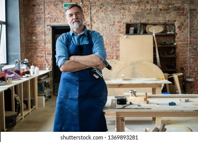 Mature handsome joiner work in carpentry. He is successful entrepreneur at his workplace - Powered by Shutterstock