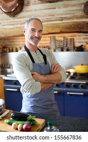 Mature Handsome Man Cooking In Home Kitchen