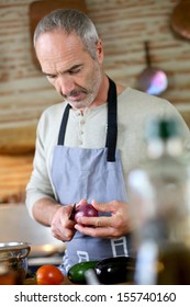 Mature Handsome Man Cooking In Home Kitchen