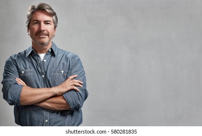 Mature Handsome Man Portrait Over Gray Wall Background