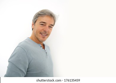 Mature handsome man standing on white background