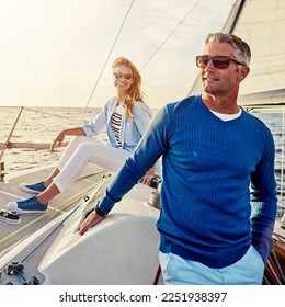 Mature, happy couple or retirement sailing yacht on ocean, sea or water relax holiday, wealth vacation or success summer. Smile, man or woman on luxury boat in investment, travel or freedom adventure - Powered by Shutterstock