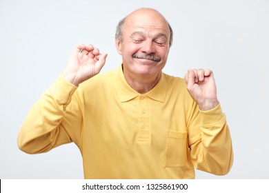 Mature happy man moving dancing over white background.
