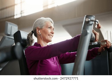 Mature, happy woman and chest press with machine for workout, fitness or indoor exercise at gym. Active female person with earphones on equipment for strength, muscle or training music at health club - Powered by Shutterstock