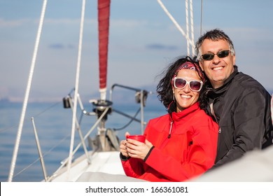 Mature Heterosexual Couple Enjoying On The Bow Of A Sail Boat