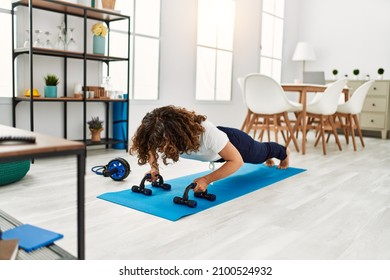 Mature Hispanic Woman Doing Exercise At The Living Room At Home