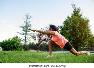 Mature Hispanic Woman Stretching Hamstring In The Park