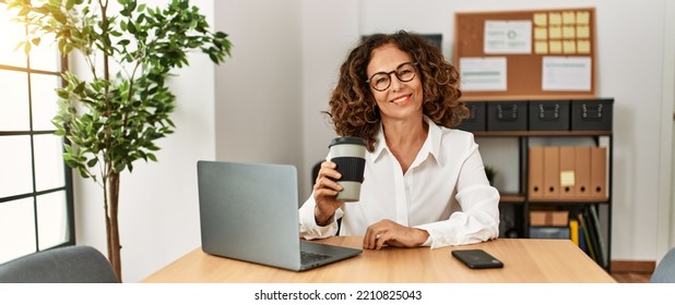Mature Hispanic Woman Working Using Computer At The Office