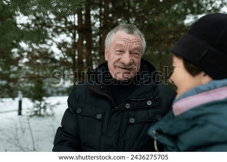 Mature husband and wife love each other and walk even in cold weather