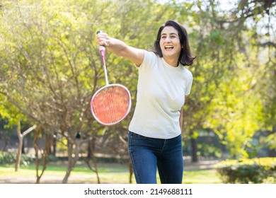 Mature indian woman playing badminton in the park. urban asian sporty female having fun outdoor sports and game  summer activity concept. - Powered by Shutterstock