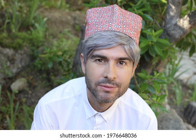 Mature islamic man wearing traditional embroidery hat