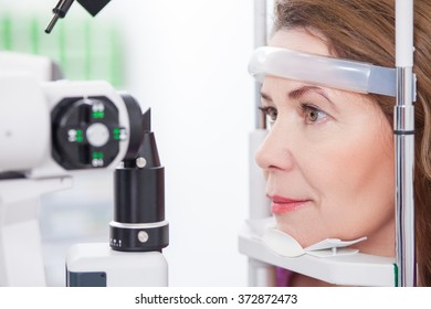 Mature Lady Is Looking Into Eye Test Machine