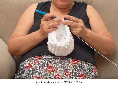 Mature Latina Woman Knits At Home, Learning Handicrafts Online.