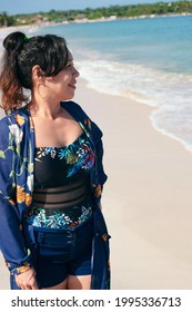 Mature Latina Woman Standing On The Beach Looking At The Horizon