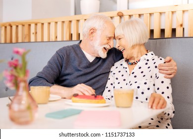 Mature love. Satisfied senior couple embracing and posing at cafe - Powered by Shutterstock