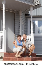 Mature Loving Couple Sitting On The Front Steps