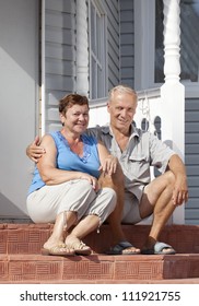 Mature Loving Couple Sitting On The Front Steps