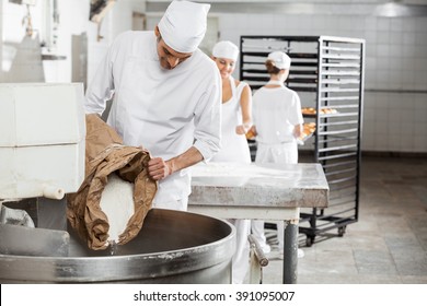 Mature Male Baker Pouring Flour In Kneading Machine - Powered by Shutterstock