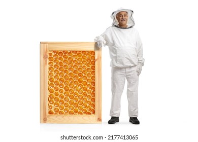 Mature male bee keeper in a uniform leaning on a honeycomb frame isolated on white background - Powered by Shutterstock